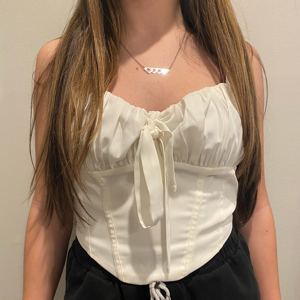 white cute corset top with a bow in front